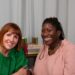 two women smiling in a podcast studio