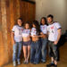 group of individuals posing in matching tshirts