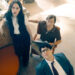 Rachel Brosnahan Skyler Gisondo and David Corenswet watch a report intently in the newsroom in Superman. .