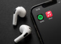 Apple Music and Spotify icons next to AirPods
