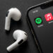 Apple Music and Spotify icons next to AirPods