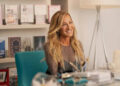 portrait of a woman seated at a modern desk in a stylish office