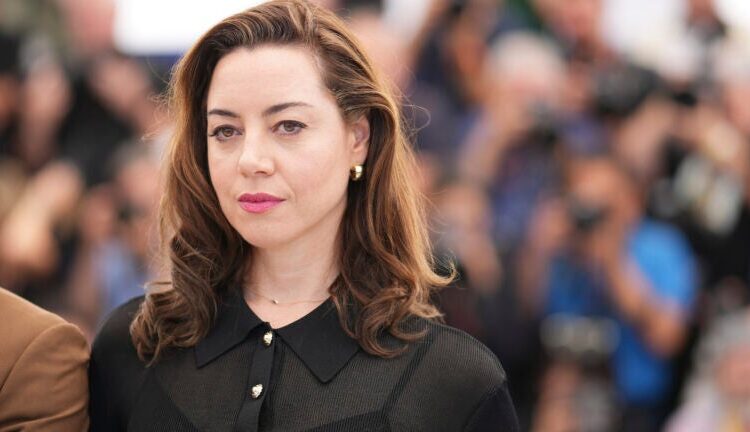 Aubrey Plaza poses for photographers.