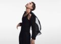 a figure in a black outfit in a dynamic pose