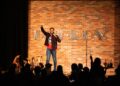 Unaka onstage at the Improv comedy club.