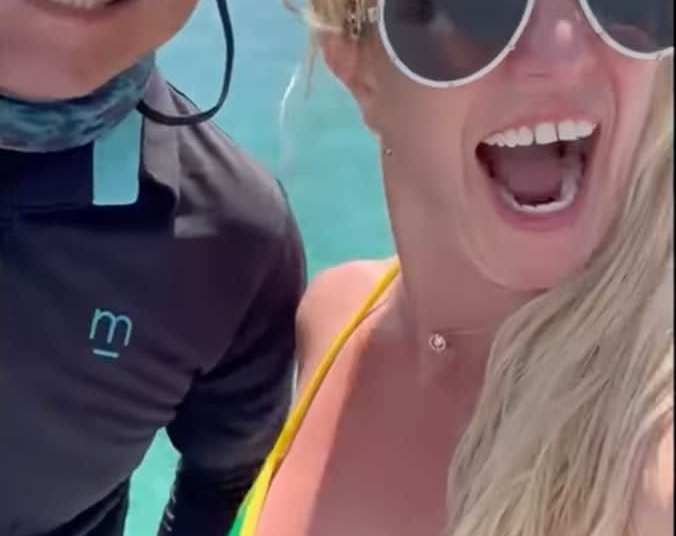Britney Spears shows excitement as she dances to Justin Timberlake's song while on a yacht
