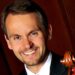 white man wearing suit and red tie holds cello, Christopher Hutton