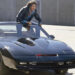 Michael Knight (David Hasselhoff) stands up through the sunroof of KITT in Knight Rider.
