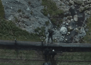 Aerial view of people working near a rocky stream.