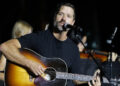 Walker Hayes with his guitar on stage in 2024.