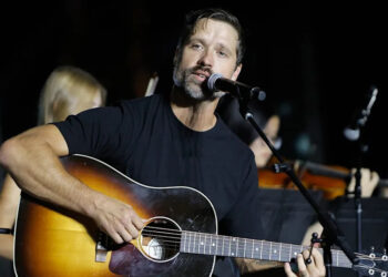 Walker Hayes with his guitar on stage in 2024.