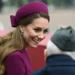 A smiling woman in a purple hat talks with an older man wearing a gray cap.