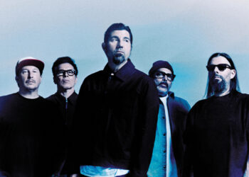 Deftones looking serious against a light blue backdrop