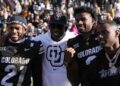 Nov 29, 2024; Boulder, Colorado, USA; Colorado Buffaloes safety Shilo Sanders (21) and head coach Deion Sanders and quarterba