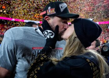 FILE - Kansas City Chiefs tight end Travis Kelce and Taylor Swift kiss after the AFC Championship NFL football game against the Buffalo Bills, Jan. 26, 2025, in Kansas City, Mo. (AP Photo/Ashley Landis, File)