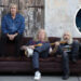 Spinal Tap seated on a sofa in the street and (inset) Elton John singing.