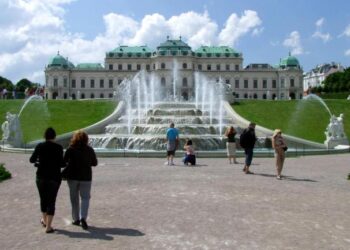 FILE - Tourists enjoy the sunny weather in front of Vienna's Belvedere Palace Austria, on Thursday, June 24, 2010. (AP Photo/Hans Punz, File)