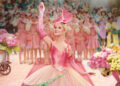 Wicked Poster featuring Glinda waving against a blurry background.