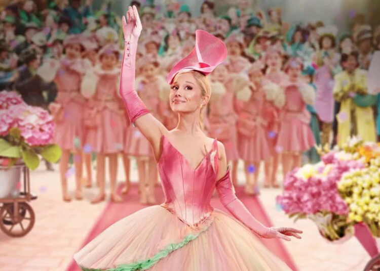 Wicked Poster featuring Glinda waving against a blurry background.