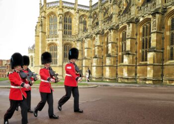 four royal guard marching outside palace