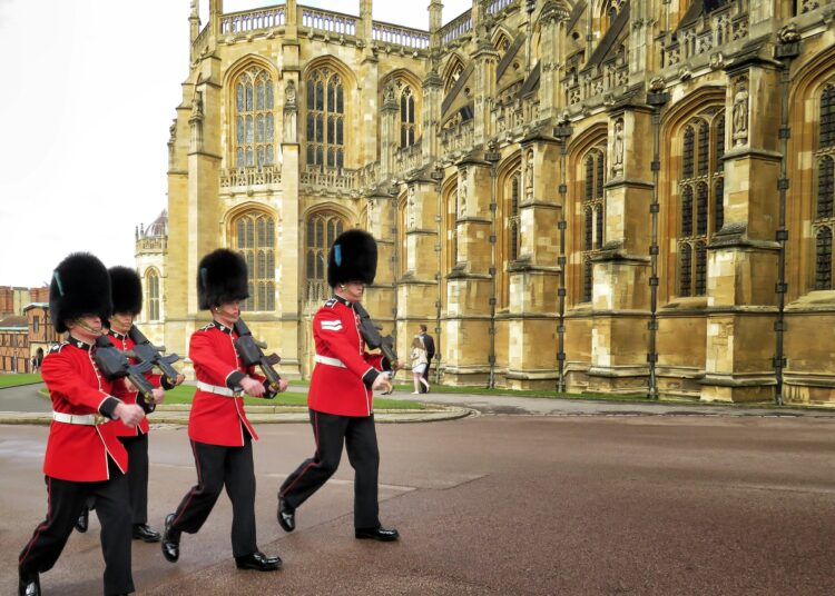 four royal guard marching outside palace