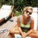 Princess Diana smiles while sunbathing on a lounger on the Caribbean island of Barbuda in 1996