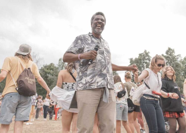 Edgard Gouveia at the PxP Festival in Berlin, photographed on June 18 2023. He organized a circle dance where people form big circles and the dance spontanously together while a sond plays for 3-4 minutes. The atmosphere he created during that dance was very impressive. In the end he asked people to hug at least 5 other people. Many people came to him to thank and hug him.