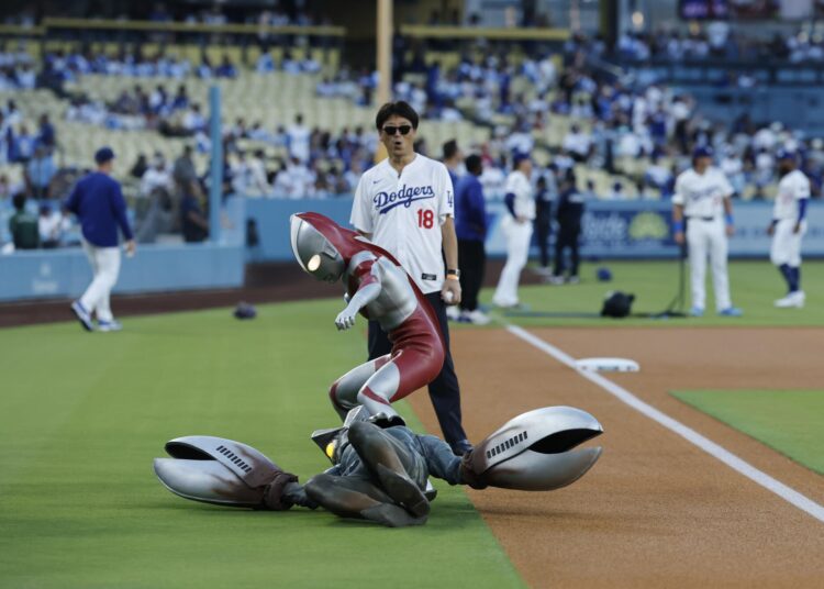 Ultraman takes down Alien Baltan before before the ceremonial first pitch on Tuesday night at Dodger Stadium.