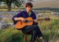 Chris Brain, the British folk singer-songwriter, plays his Sigma 12-fret acoustic in a rural setting.