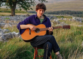 Chris Brain, the British folk singer-songwriter, plays his Sigma 12-fret acoustic in a rural setting.