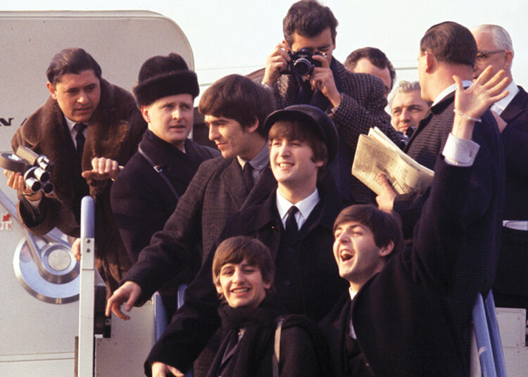 (L-R) George Harrison, Ringo Starr, John Lenon, and Paul Mccartney arriving at JFK airport in 'Beatles 64.'