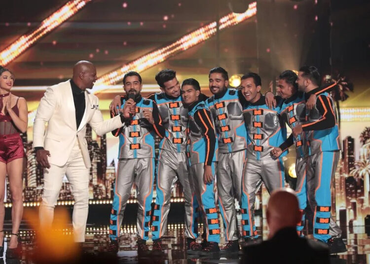 The Unreal Crew stands onstage with Terry Crews on AGT Episode 2013.
