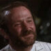 A close up of Robin Williams with a beard, smiling.