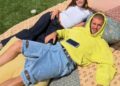 two people lounging on a picnic blanket