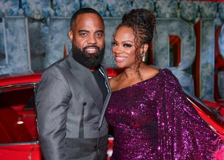 Kandi Burruss posing with husband, Todd Tucker, at the RED HOT Fifty Birthday Celebration For Tameka "Tiny" Harris.