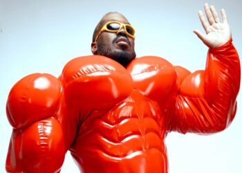 Kiddy Smile posed In inflatable red outfit
