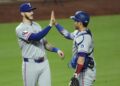 Texas Rangers' Jonah Heim, left, and Kyle Higashioka celebrate after their baseball game against the Kansas City Royals, Wednesday, Aug. 20, 2025, in Kansas City, Mo. (AP Photo/Charlie Riedel)
