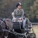 Lady Louise Windsor smiling as she drives a carriage