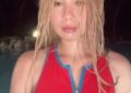 Lil Tay with wet hair wearing a red zip-up top while appearing in a nighttime video