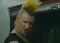 Matt Smith with a big orange and yellow punk mohawk as Russ in Caught Stealing.