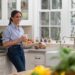 Meghan Markle in a kitchen, holding a mug.