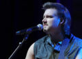 Morgan Wallen wears denim vest on stage