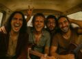 An AI-generated image of for men, dripping with sweat and smiling in the back of a van. Two have guitars in their hands.