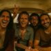 An AI-generated image of for men, dripping with sweat and smiling in the back of a van. Two have guitars in their hands.