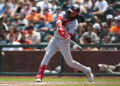 CJ Abrams swinging a bat in a grey uniform with grey lettering and a red shin guard against the Giants