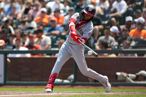 CJ Abrams swinging a bat in a grey uniform with grey lettering and a red shin guard against the Giants