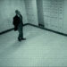 A man in a suit walking through a vault, as seen through a security camera in Stolen: Heist of the Century.
