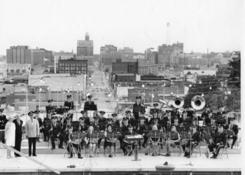 A photo of the Des Moines Metro Concert Band performing at the Iowa Capitol as it appeared in the Des Moines Register in 1973. Third from the left is the conductor of the band at the time, Robert W. Bagley.