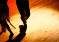 Couple dancing under the spotlights. (Getty Images)
