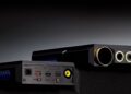 Two views showing the connections on the top and bottom of the FiiO M27 portable player. They're shot on a dark surface against a dark grey background